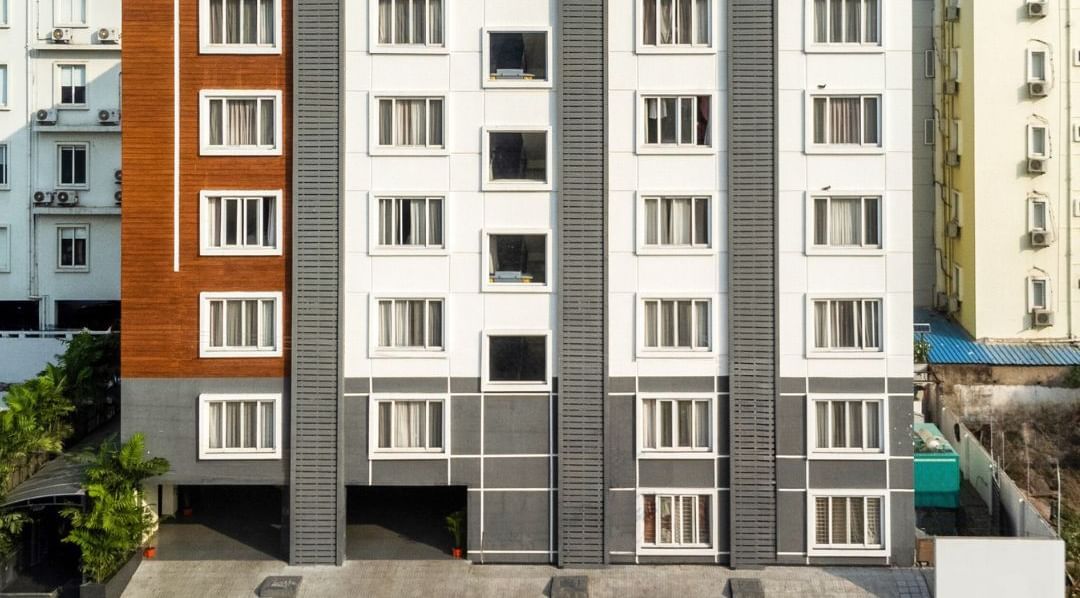 Facade of Destino by Monday Hotels featuring a multi-storey building under a partly cloudy sky.
