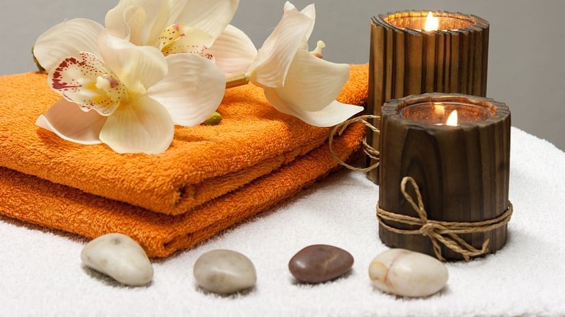 Saffron towels, lit candles and pebbles 