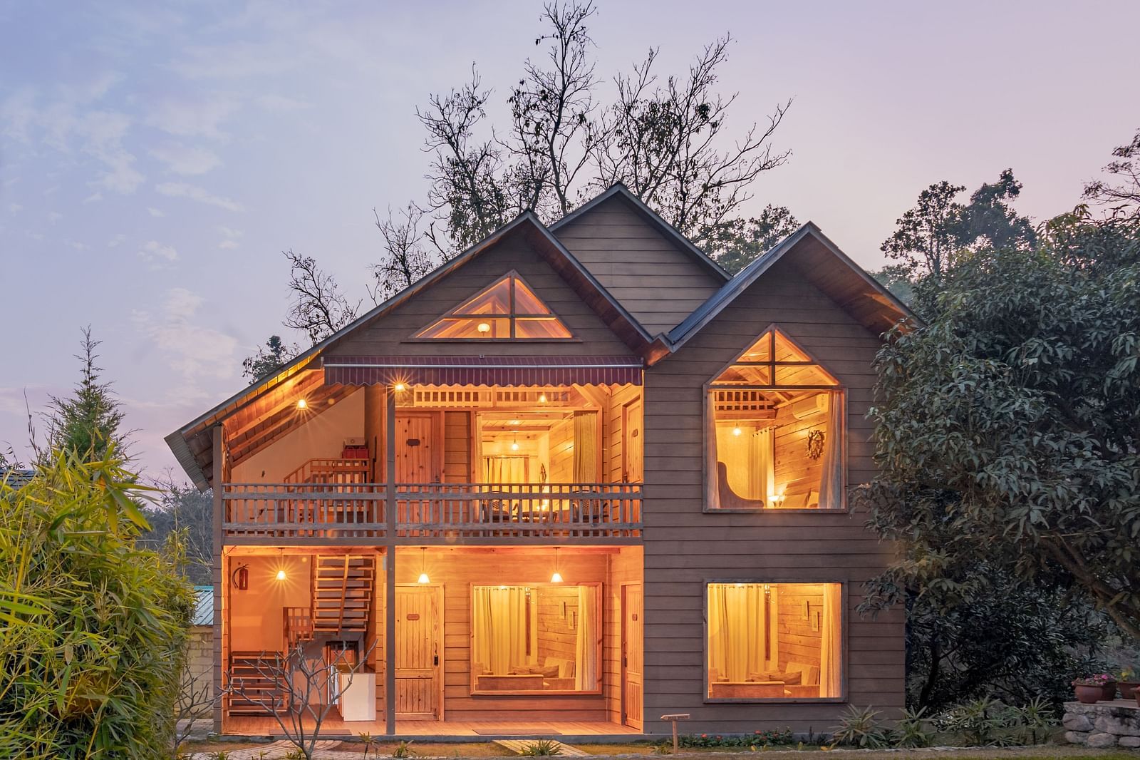 Facade view of Pinewood Cottage at dusk at the Sylvan Retreat, Dehradun.