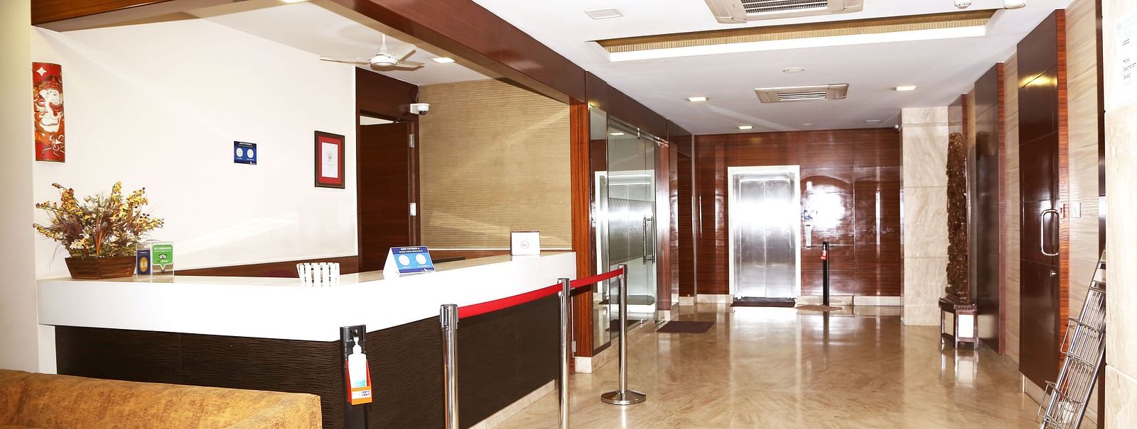 Reception area with front desk and wooden wall panels at Fressotel Seetharam, Coimbatore