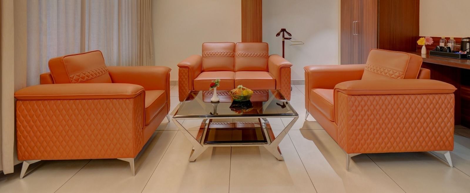 Image of a seating area with sofas and a table in the middle at Hari Govindas, Siddappa Square.