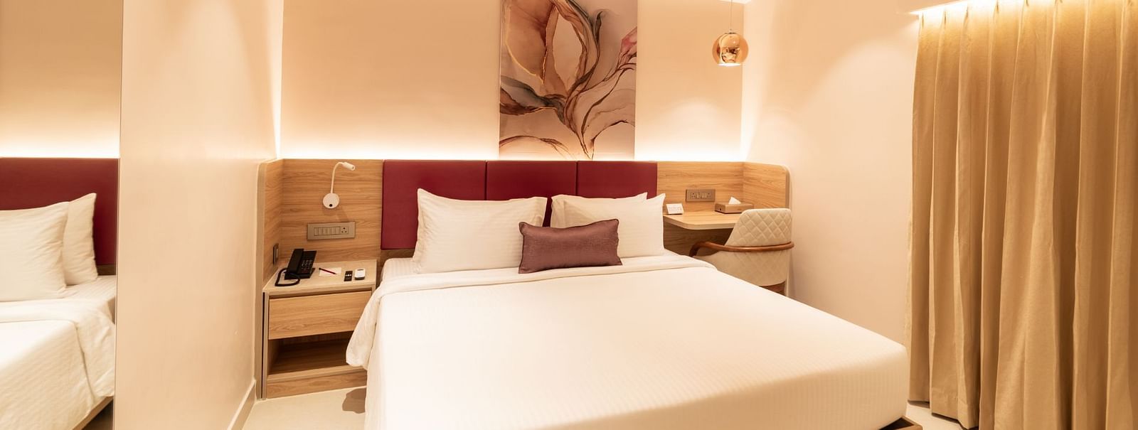 Elegant bedroom with soft lighting in The Executive Rooms at TGI Livancia The Sojourn, Bangalore.