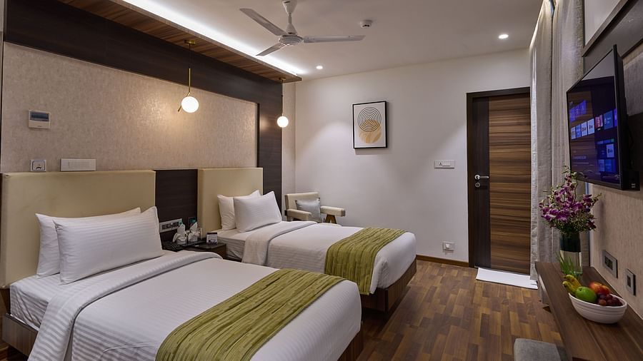 Twin beds with side tables inside execitive room at Grand Continent - A Sarovar Premiere Affiliate Hotel, Hosur