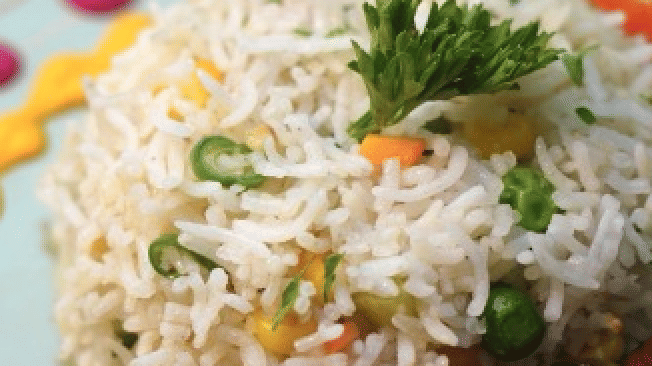 A beautifully plated dish with rice, meat skewers, and fresh herbs at Cenneys Gateway - Pride of Salem.