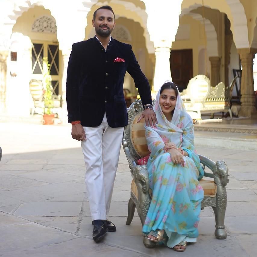Mrs. Nityasri Rathore & Mr. Divyraj Singh Karansar standing in the open courtyard at Dileep Kothi, Jaipur during the day