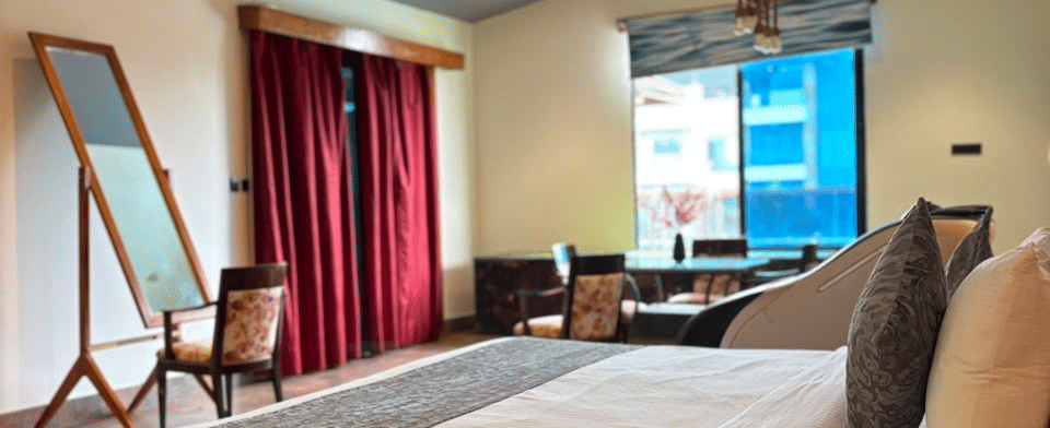 Sky Suite, King bed with dresser mirror and window seating