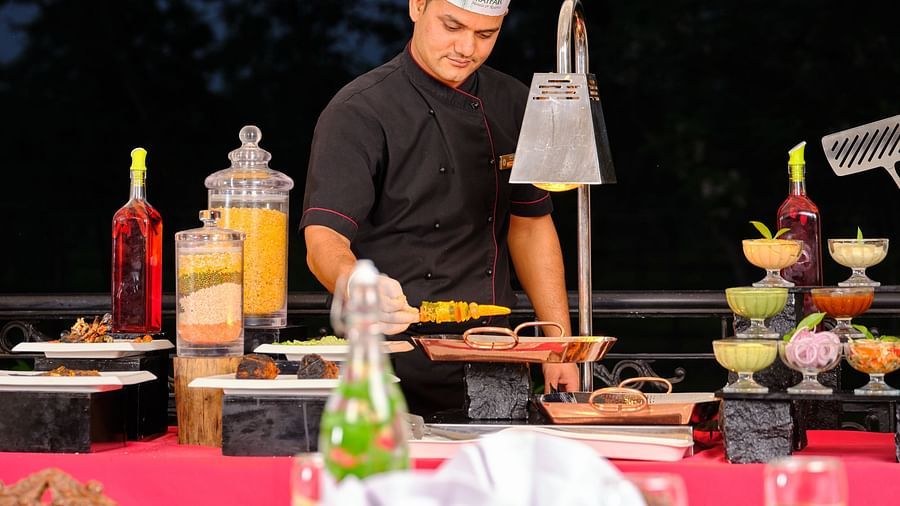 a chef cooking at the barbecue station -  Mayfair Tea Resort, Siliguri  1