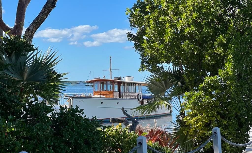 The Blue Mist sailboat standing still amid tranquil waters below a clear blue sky at Casa Morada.