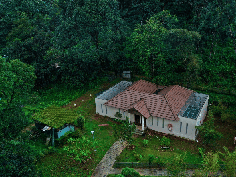 Aerial view of the Private Pool Villa surrounded by lush trees and landscaped gardens – Abad Brookside Lakkidi, Wayanad
