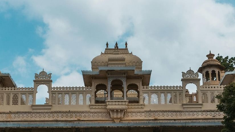 A close up image of an architecture with clouds in the background