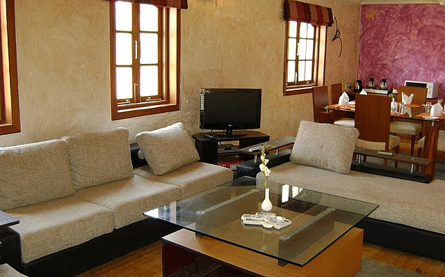 Living area featuring sofa sets arranged around the coffee table