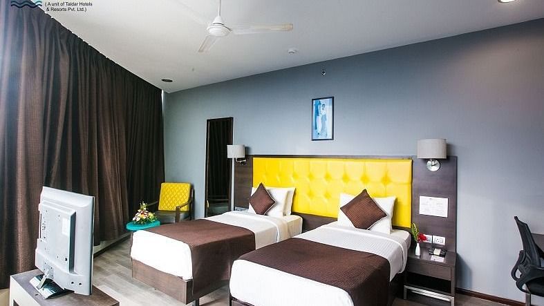 Permium Room with twin beds and a television at Hotel Mumbai House, Airoli