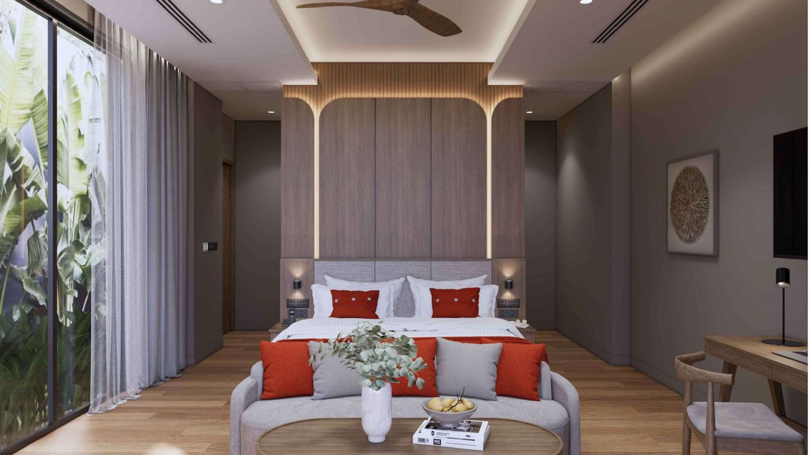 A room with a king size bed, red and grey cushions, wooden furniture, sofa with coffee table, and full-length windows opening to garden views at Ramada Resort by Wyndham Khao Lak.