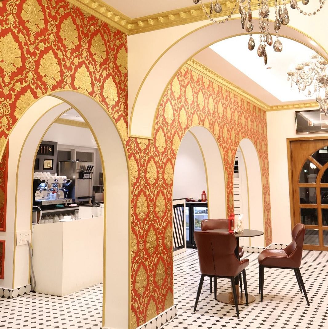 Chic indoor bistro with ornate wallpaper and elegant chandeliers