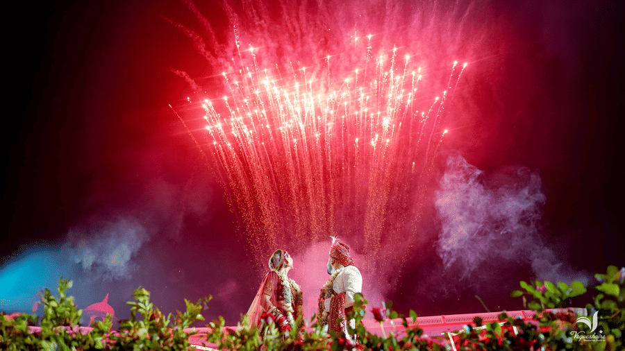 Grand fireworks display lighting up the sky during a wedding celebration at Umaid Palace.
