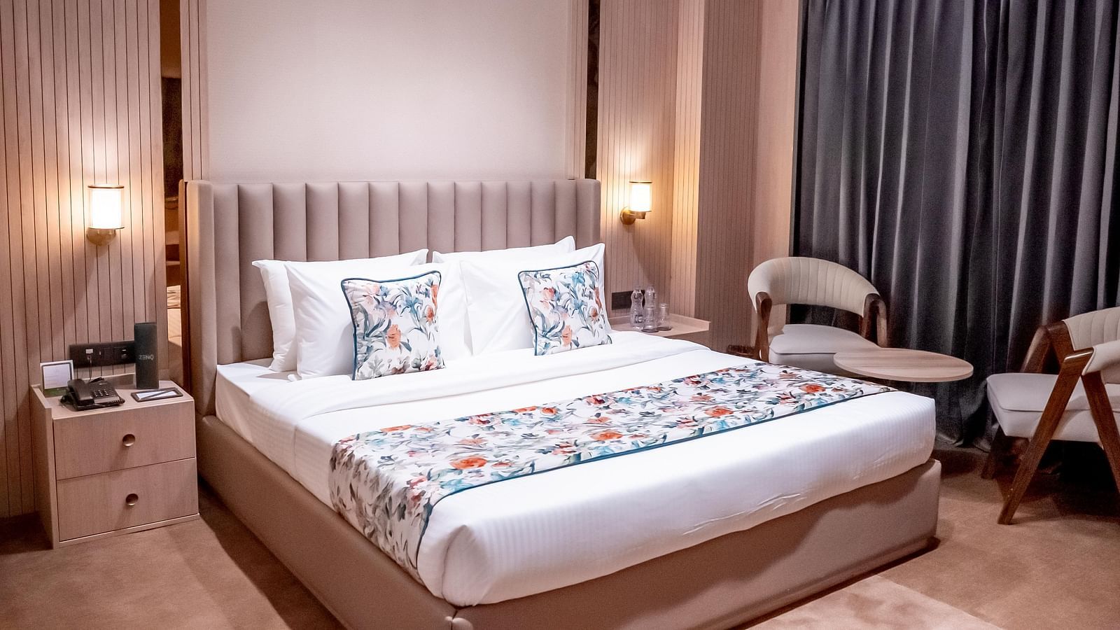 Executive Suite with a bed, bed side tables, chairs and a window with a curtain in the background at ASTER GRAND BY ZENQ SAKET.