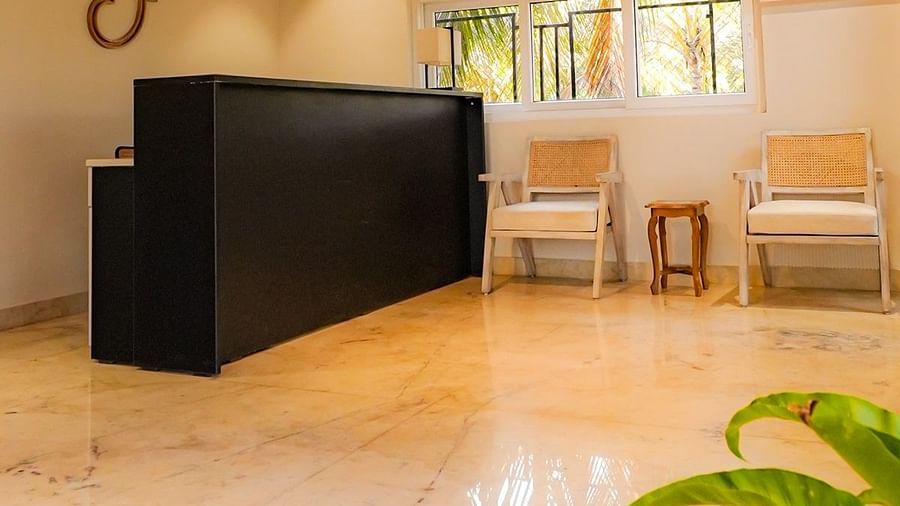 A lobby area with a polished floor, a black front desk, and arched windows at Kssemya
