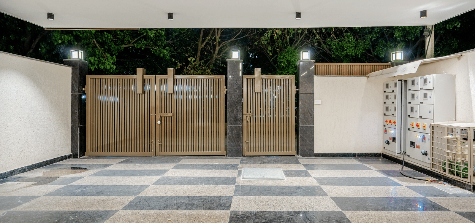 Spacious and secure car parking area with tiled flooring at Lime Tree 1BHK Service Apartment Near Artemis Hospital Gurgaon.