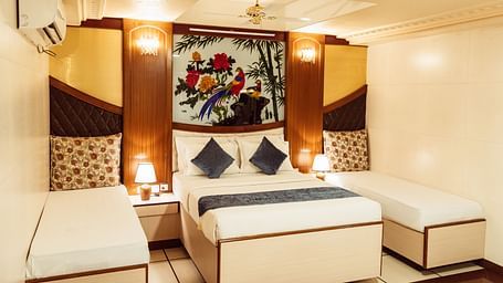 image featuring a double bed along with twin beds besides it at The Grand Krishna Rooms, Bengaluru
