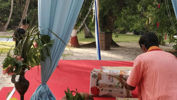 a man placing fruits on the wedding stage