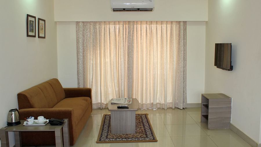 An entire view of the living room with a brown couch and a coffee table