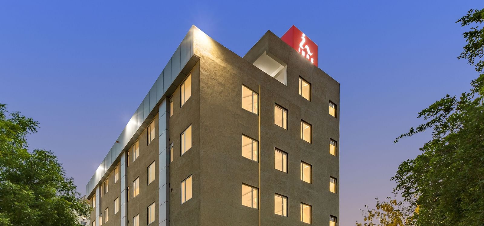 Facade image of  Inde Hotel Cyber City with backdrop of blue sky