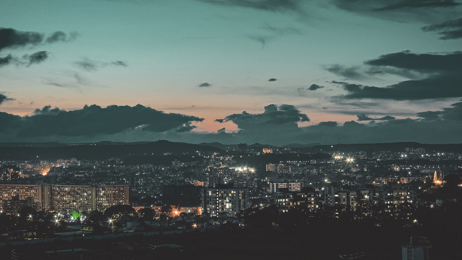 A city skyline seen from a vantage point at night