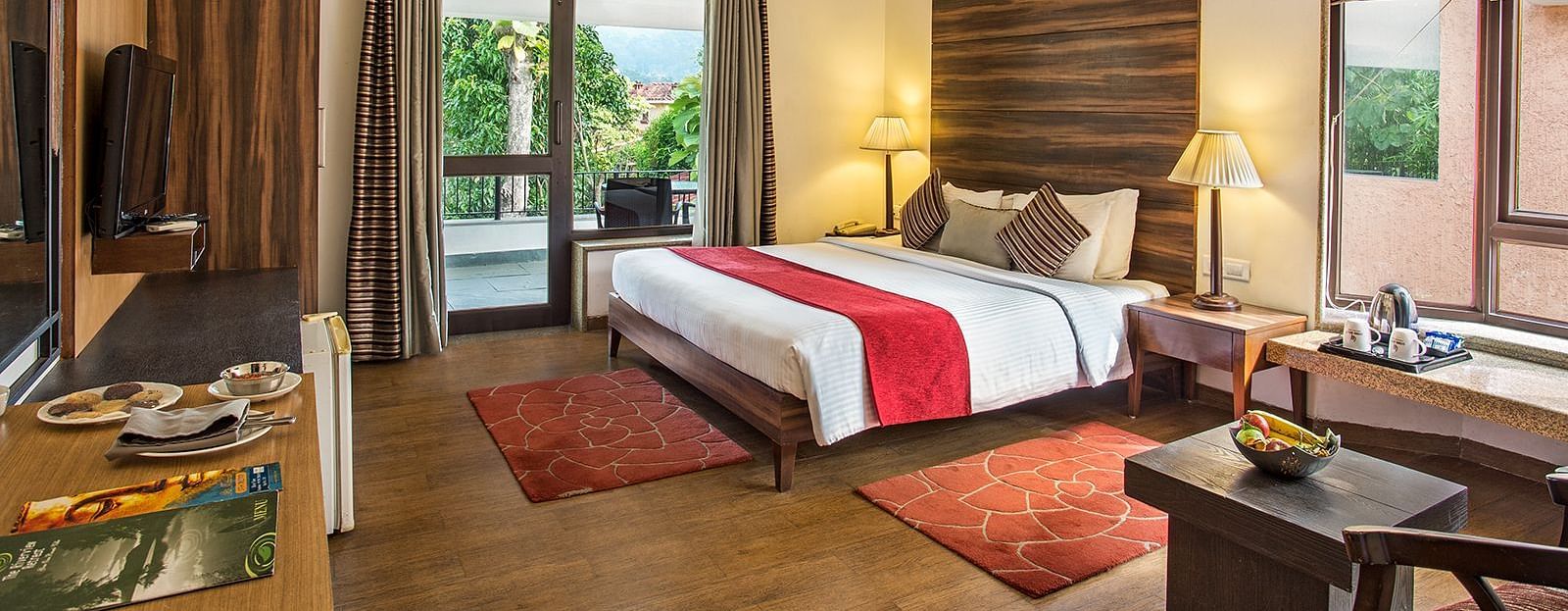 An image of a bedroom with king size bed, bedside table and lamp,  flat TV screen,  a cabinet , fan, and an open window - The Riverview Retreat, Corbett