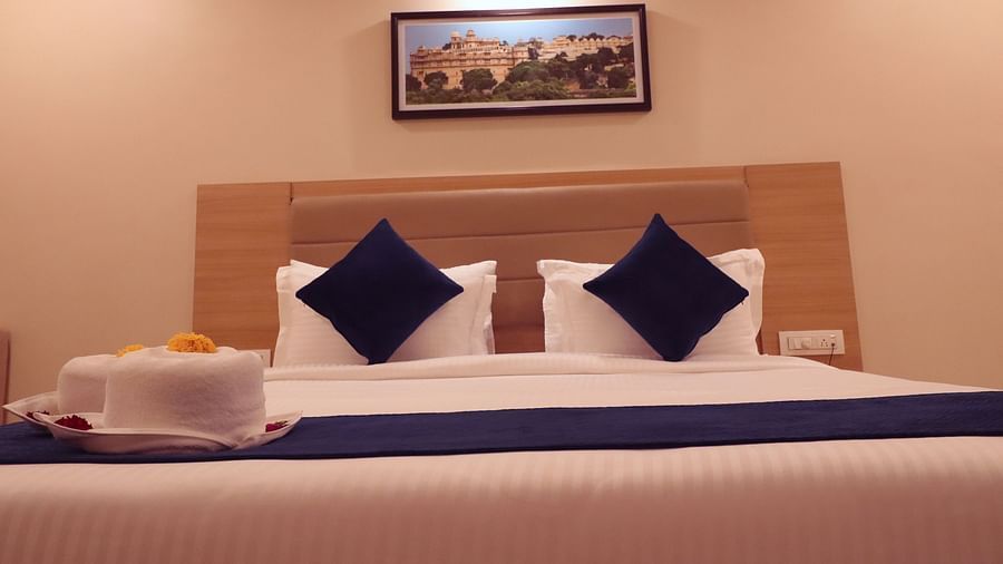 Image of Premium Room with a bed and a photo frame above the bed at Clarks Inn Express, Udaipur.