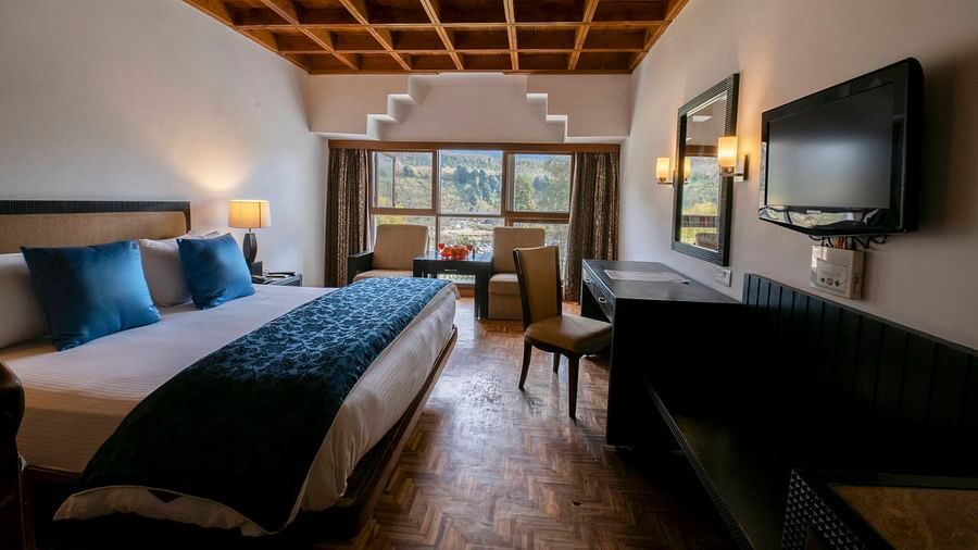 a view of Duplex at Mastiff Grand, Manali featuring wooden furnishing and comfy bed