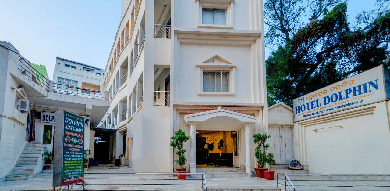 Front facade of Hotel Dolphin Puri with entrance signage and exterior architecture.