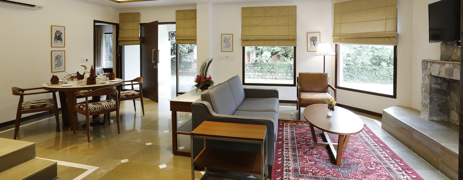 An image of a living area with sofa set and dining area on the other side. There is also a flat TV screen on the wall - The Riverview Retreat, Corbett
