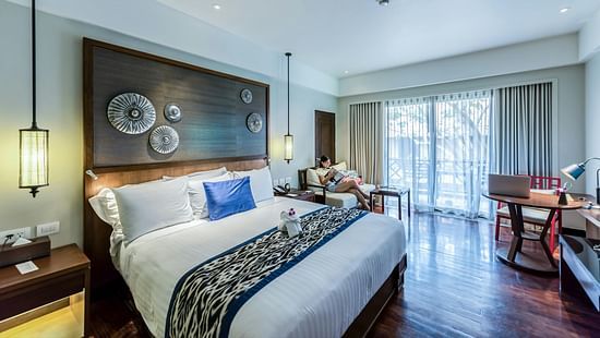 A bedroom featuring a stylishly decorated headboard with intricate patterns and soft lighting.