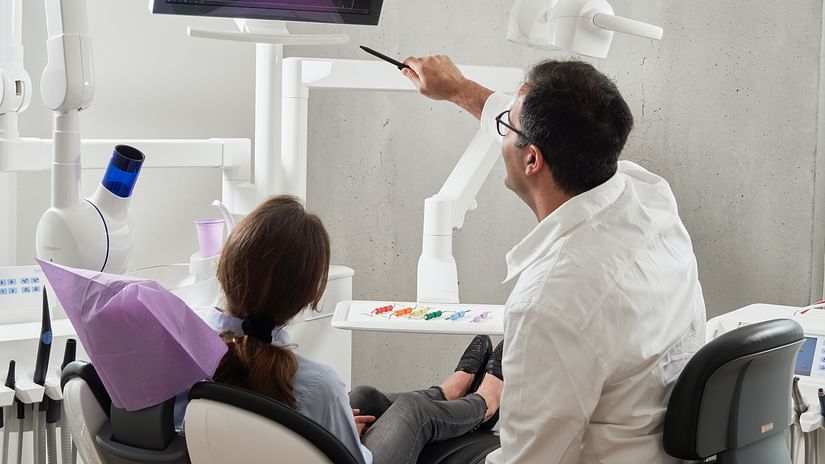 A doctor showing a patient the xray with issues in the teeth