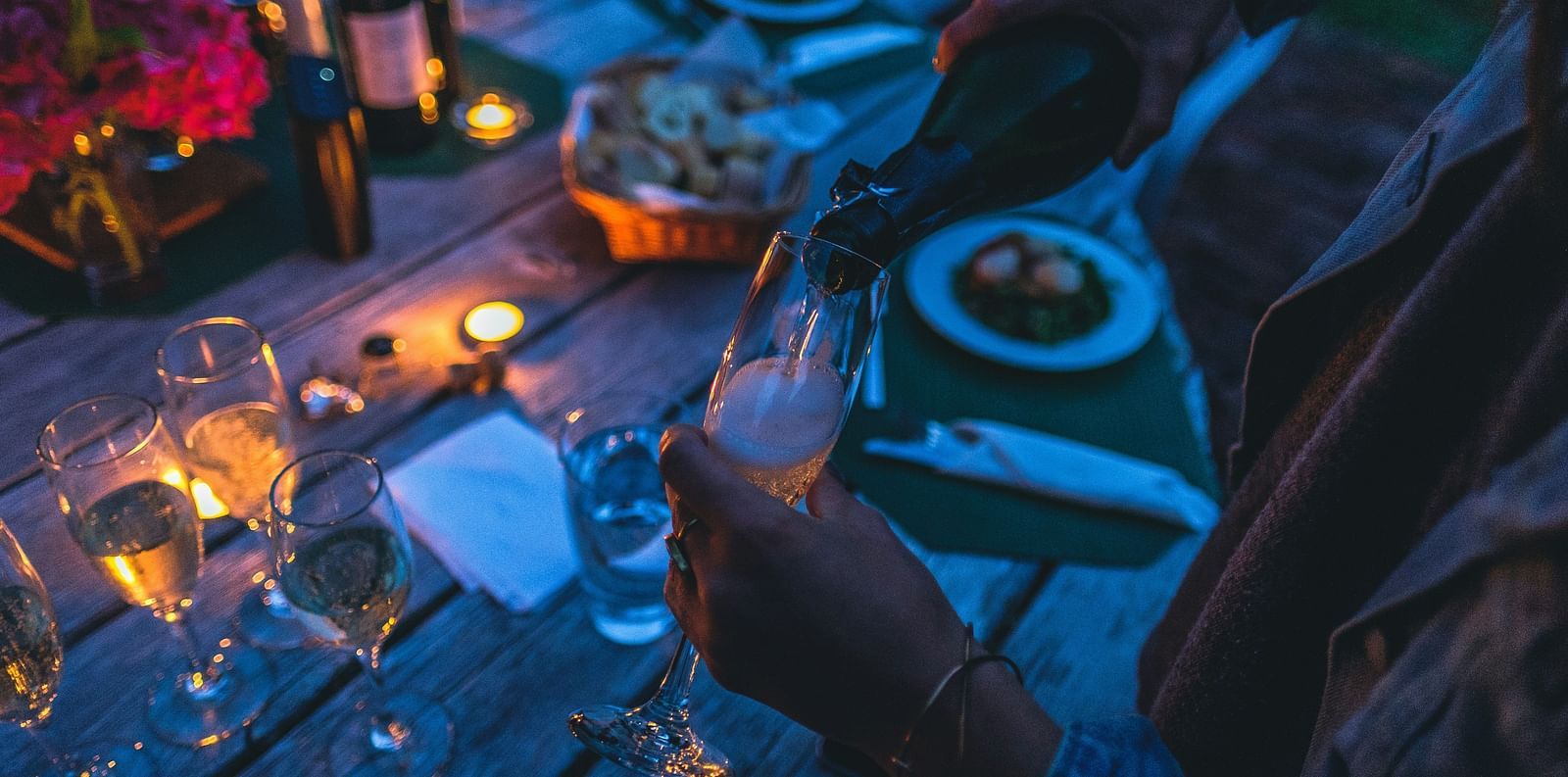 A cozy evening picnic with candles and a meal served on a low table at Ramoji Film City in Hyderabad 