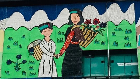 Art featuring a woman and a boy holding hands against snowy mountains - The Orchid Hotel Shimla