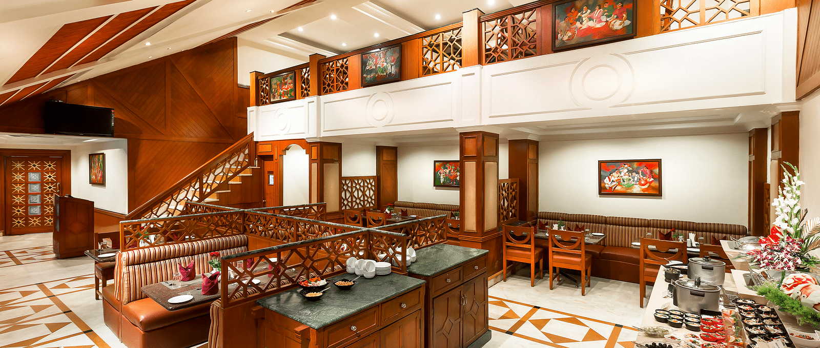 A seating arrangement of Dakshin Restaurant at Regency Kanchipuram by GRT Hotels.
