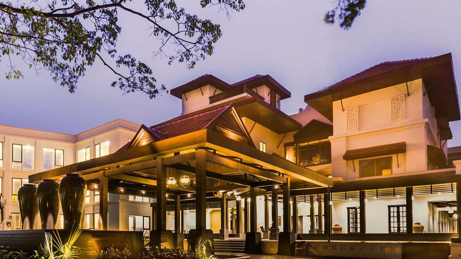 Resort facade lit with yellow lights - Rhythm Lonavala