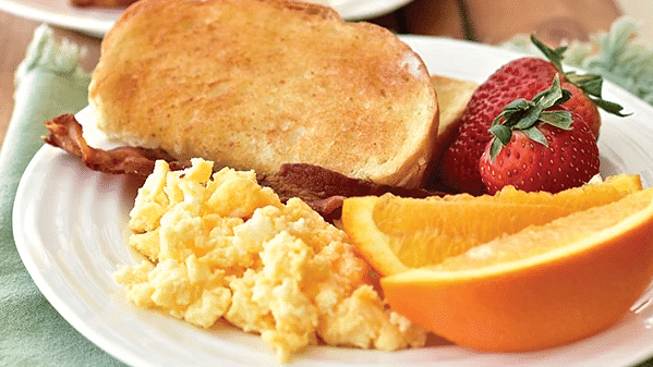 A breakfast comprising of bread, eggs, fruits and drinks - S Hotel Kingston, Jamaica