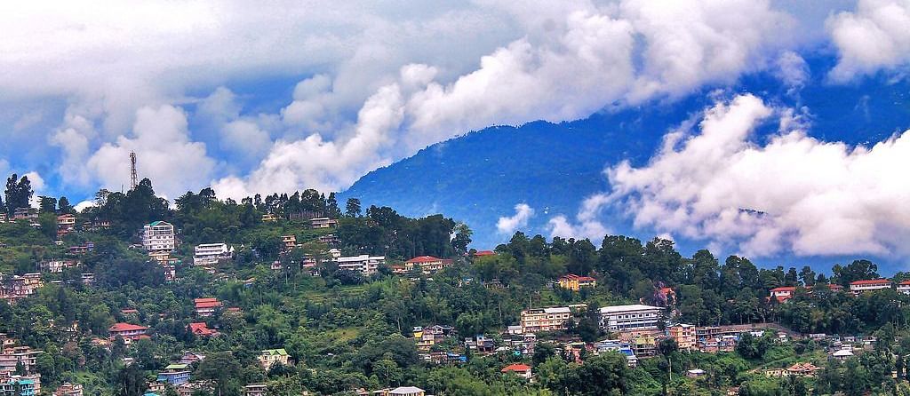 Aerial view of a town with mountains in the backdrop