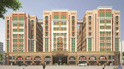 A far out facade view of La Maison Hotel, Doha, with a tree on the corner.