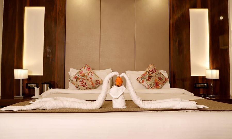 towels decorated as a swan on the double bed inside the suite at 5 flowers ananta elite, kota