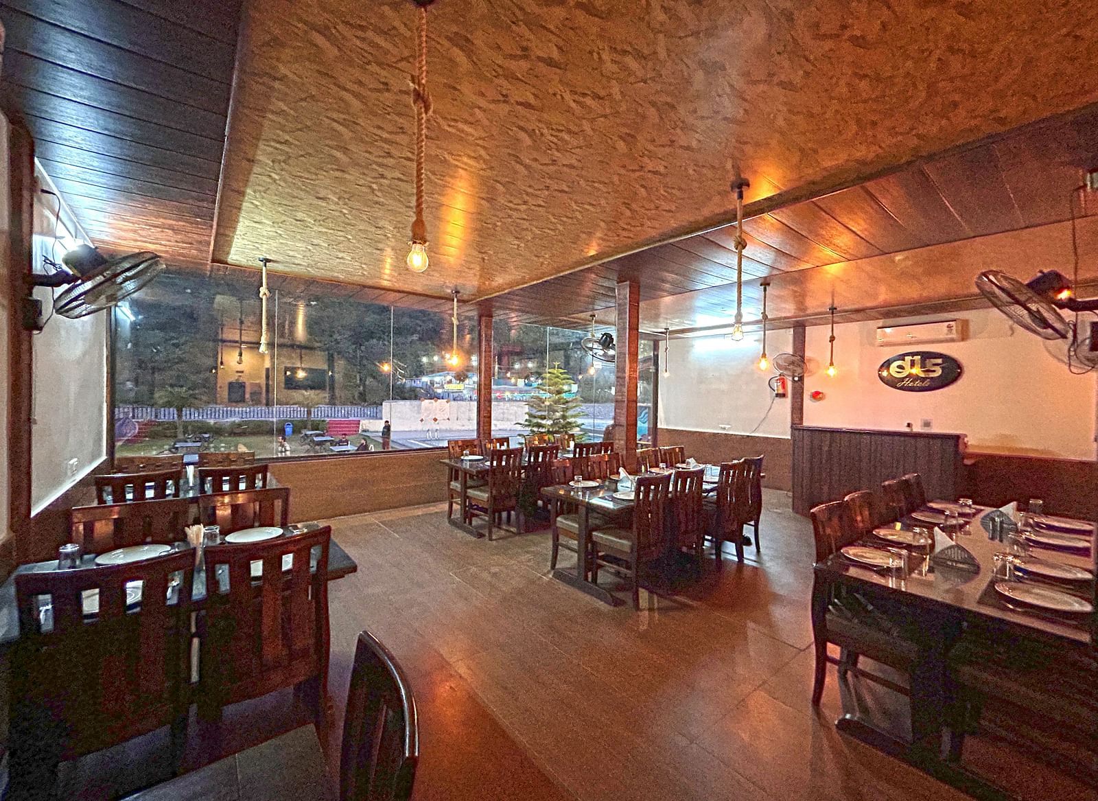 Dining area of the in-house restaurant at DLS MJ River Resort, Rishikesh.