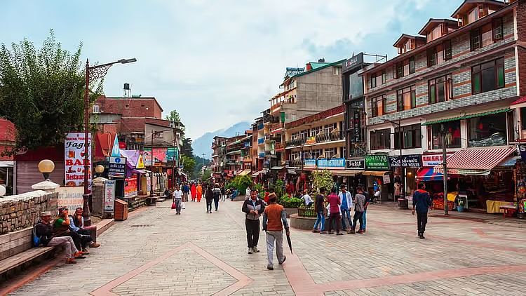 An image of a Shopping street with people bustling and building in the background