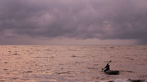 an image of Marari Beach Neemrana with a man boating 
