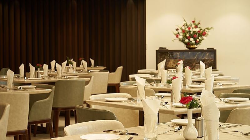 Variously arranged seating area at a restaurant at The Hamuse Hotel, Kodaikanal.