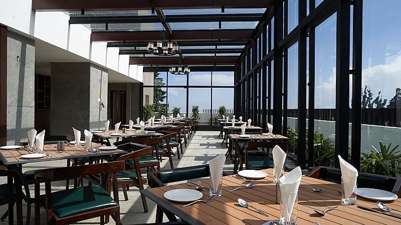 A day light view of the rooftop dining area at The Hamuse Hotel, Kodaikanal.