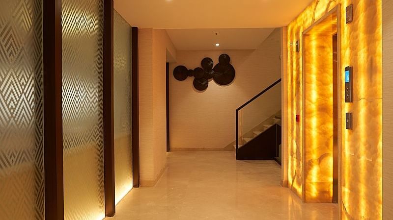 Hotel pathway showing a lift and a staircase at the end of the hall way at The Hamuse Hotel, Kodaikanal.