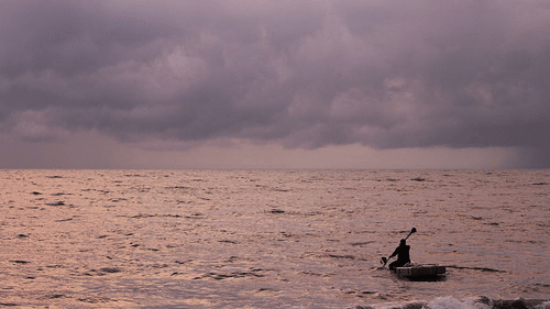an image of Marari Beach Neemrana with a man boating 