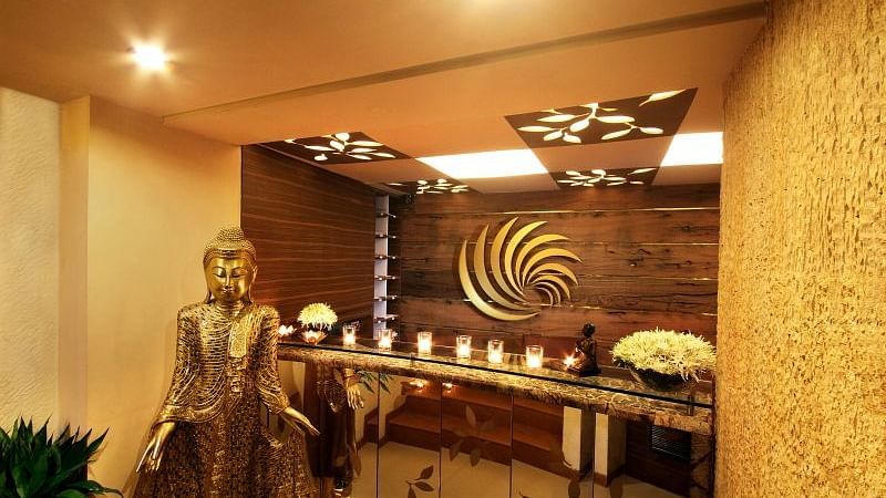 Image of reception area of IOSIS Spa & Wellness with lit up candles and Buddha statue 